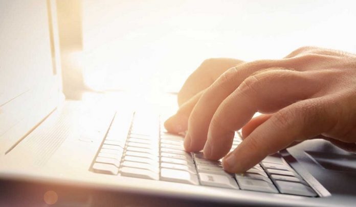 a-mans-hands-typing-on-laptop